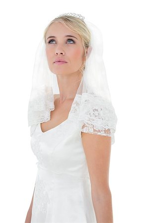 simsearch:6115-08101208,k - Thoughtful young bride looking up over white background Stock Photo - Budget Royalty-Free & Subscription, Code: 400-07342723