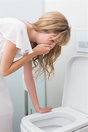 Side view of a young woman about to vomit into a toilet Stock Photo - Budget Royalty-Free & Subscription, Code: 400-07343643