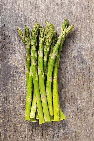 bunch of fresh green asparagus on old wood board, rustic style Stock Photo - Budget Royalty-Free & Subscription, Code: 400-07406710
