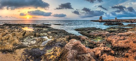 sunset over the sea and rocky coast with ancient ruins Stock Photo - Budget Royalty-Free & Subscription, Code: 400-07407834