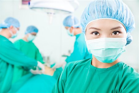Surgical woman and Surgeons  in an  operating theater Stock Photo - Budget Royalty-Free & Subscription, Code: 400-07409092