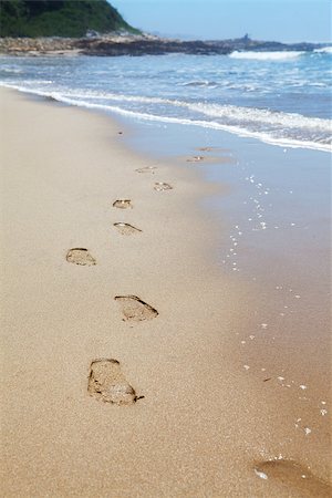 Human footprints on the beach sand with sea in background leading towards the viewer Stock Photo - Budget Royalty-Free & Subscription, Code: 400-07409581