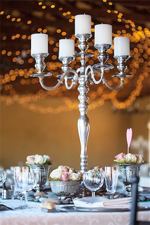 Wedding reception hall with decorated tables, selective focus with blurred fairy lights in background Stock Photo - Budget Royalty-Free & Subscription, Code: 400-07409591