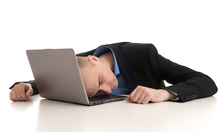 stressed businessman sleeping on a laptop. Studio shot Stock Photo - Budget Royalty-Free & Subscription, Code: 400-07409692