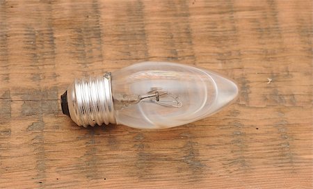 electrical light bulb explosion - old burned out light bulb on wood background Stock Photo - Budget Royalty-Free & Subscription, Code: 400-07409727