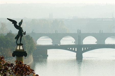 simsearch:400-06393299,k - This is a morning view of the bridges on the Vltava River in Prague, Czech Republic. Mythologycal sculpture is in the foreground. Photographie de stock - Aubaine LD & Abonnement, Code: 400-07414447
