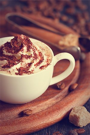simsearch:400-04603391,k - Cup of cappuccino, coffee beans and brown sugar close-up. Toned photo. Fotografie stock - Microstock e Abbonamento, Codice: 400-07414843