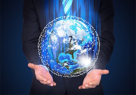Man in suit holding a earth in hand. Communication around the earth. The concept of communication Stock Photo - Budget Royalty-Free & Subscription, Code: 400-07415437