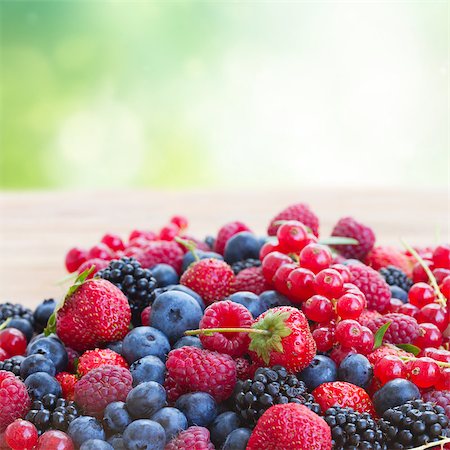 raspberry, blueberry, blackberry - ripe of  berries on wooden table in garden  - blackberry, raspberry , red currant and blueberry Stock Photo - Budget Royalty-Free & Subscription, Code: 400-07415482