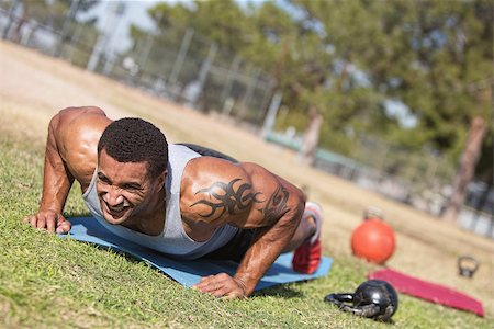 Strong man with tattoo doing push ups outdoors Stock Photo - Budget Royalty-Free & Subscription, Code: 400-07416046