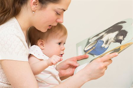 The young mother reads the book to the baby of 10 months old. Stock Photo - Budget Royalty-Free & Subscription, Code: 400-07416446