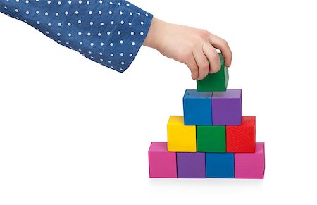 simsearch:400-04282061,k - Child's hand building a brick tower isolated on white background Stock Photo - Budget Royalty-Free & Subscription, Code: 400-07416501