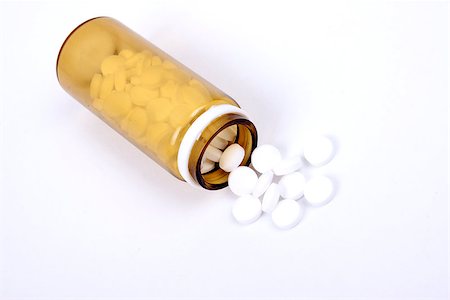 Suplements pills on the table with dose isolated on white Foto de stock - Super Valor sin royalties y Suscripción, Código: 400-07416618