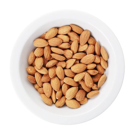 simsearch:400-06556120,k - heap of almond nuts in bowl, isolated on white background Fotografie stock - Microstock e Abbonamento, Codice: 400-07417536