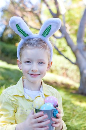 cheerful smiling boy with bucket full of colorful easter eggs at spring time Stock Photo - Budget Royalty-Free & Subscription, Code: 400-07417545