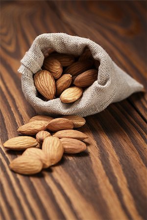 small sack bag full of almonds, on wooden table Stock Photo - Budget Royalty-Free & Subscription, Code: 400-07417540