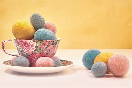 simsearch:400-07406705,k - Brightly colored eggs in tea cup on yellow background Foto de stock - Super Valor sin royalties y Suscripción, Código: 400-07418204