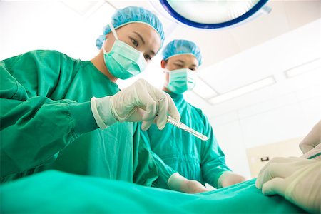 Professional aesthetic medicine surgeon operating  with scalpel Stock Photo - Budget Royalty-Free & Subscription, Code: 400-07418302