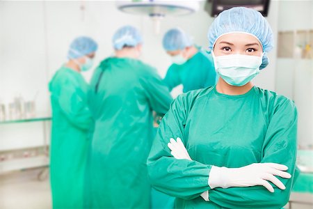 confident female surgeons  crossed hands with  teams Stock Photo - Budget Royalty-Free & Subscription, Code: 400-07418303
