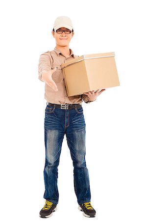 smiling  delivery man holding parcel and standing Stock Photo - Budget Royalty-Free & Subscription, Code: 400-07418320