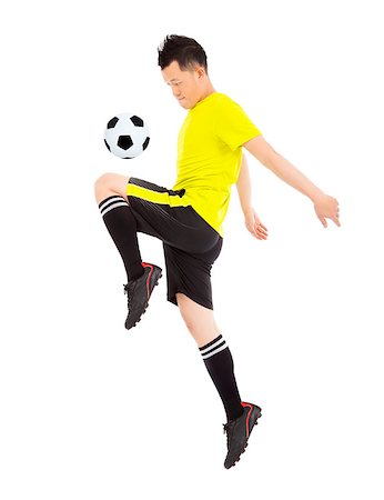 foot kick - soccer player jumping to stop the ball Stock Photo - Budget Royalty-Free & Subscription, Code: 400-07418345