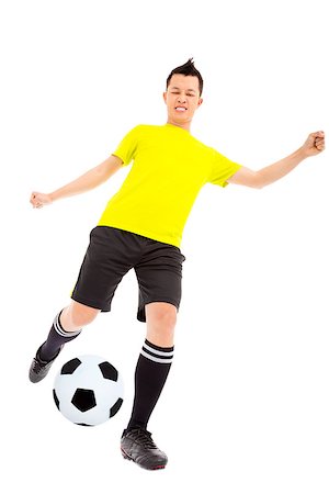 simsearch:400-04325504,k - Soccer player kicking ball Fotografie stock - Microstock e Abbonamento, Codice: 400-07418348