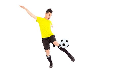 simsearch:400-04325504,k - Young soccer player kicking ball Fotografie stock - Microstock e Abbonamento, Codice: 400-07418340