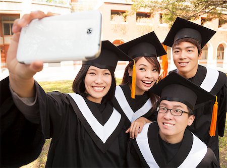 group of graduates  taking picture with cell phone Stock Photo - Budget Royalty-Free & Subscription, Code: 400-07418358