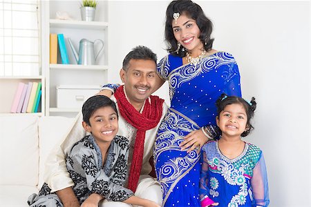 Portrait of happy Indian family at home. Living lifestyle of parents and children in their traditional dress in modern house. Stock Photo - Budget Royalty-Free & Subscription, Code: 400-07418391