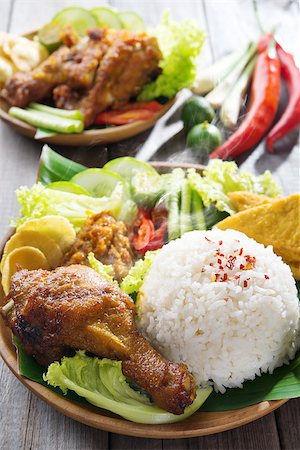 fried chicken with banana - Famous traditional Malay food. Delicious nasi ayam penyet with sambal belacan. Local flavor. Fresh hot with steam smoke. Stock Photo - Budget Royalty-Free & Subscription, Code: 400-07418405