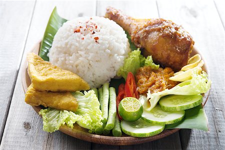 fried chicken with banana - Famous traditional Indonesian food. Delicious nasi ayam penyet with sambal belacan.  Fresh hot with steam smoke. Stock Photo - Budget Royalty-Free & Subscription, Code: 400-07418406