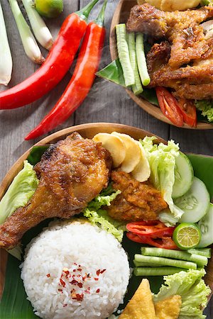 fried chicken with banana - Popular Indonesian local food nasi ayam penyet, indonesian fried chicken rice. Fresh hot with steam smoke. Stock Photo - Budget Royalty-Free & Subscription, Code: 400-07418408