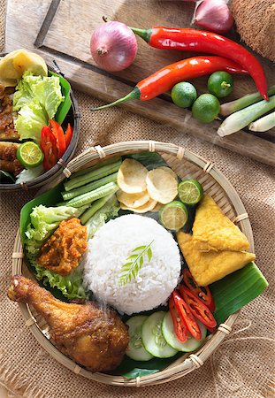 fried chicken with banana - Popular Indonesian local food nasi ayam penyet, indonesian fried chicken rice with sambal belacan. Fresh hot with steam smoke. Stock Photo - Budget Royalty-Free & Subscription, Code: 400-07418402