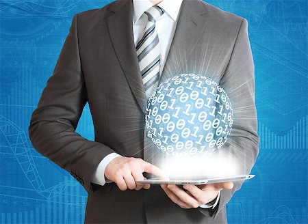 Man in suit holding tablet pc and digital sphere in hand. The computer technologies concept Stock Photo - Budget Royalty-Free & Subscription, Code: 400-07419614