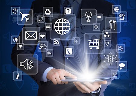 simsearch:400-07446368,k - Man in suit holding tablet pc and application icons in hand. The concept of software Foto de stock - Super Valor sin royalties y Suscripción, Código: 400-07419649