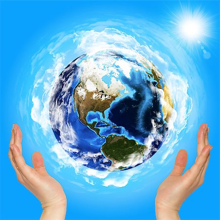 Hands holding earth. Blue sky on background Stock Photo - Budget Royalty-Free & Subscription, Code: 400-07419672