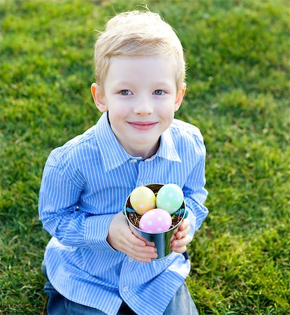 easter humour - cute smiling boy with basket full of colorful easter eggs at spring time Stock Photo - Budget Royalty-Free & Subscription, Code: 400-07419742