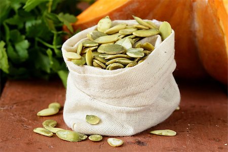 simsearch:400-06954534,k - peeled pumpkin seeds and fresh pumpkin on a wooden table Stock Photo - Budget Royalty-Free & Subscription, Code: 400-07419792