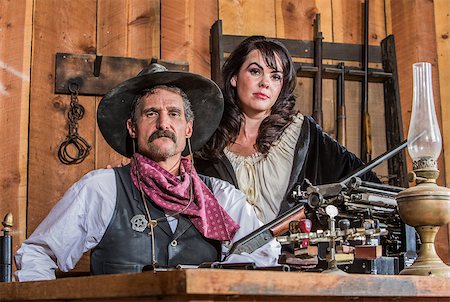 simsearch:400-07516134,k - Gruff Cowboy Poses With A Rifle And Stern Saloon Girl Stock Photo - Budget Royalty-Free & Subscription, Code: 400-07410139