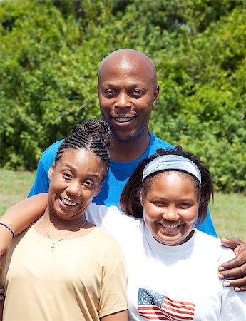 family portrait with flags - African-american family consisting of father, mother, and adolescent daughter.  Mother has cerebral-palsy. Stock Photo - Budget Royalty-Free & Subscription, Code: 400-07411012