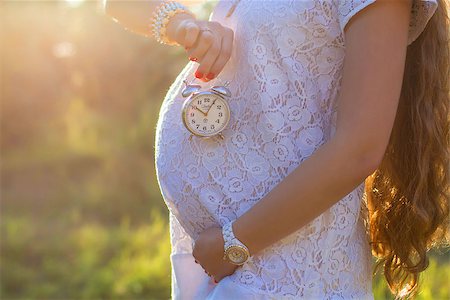 family outdoors and bright sun - Close up of pregnant belly in nature Stock Photo - Budget Royalty-Free & Subscription, Code: 400-07411209