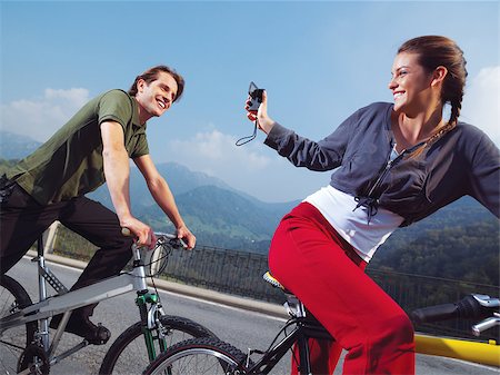 simsearch:400-04336561,k - The happy couple on bicycles in the park Fotografie stock - Microstock e Abbonamento, Codice: 400-07411631
