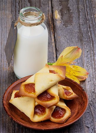 simsearch:400-07420117,k - Homemade Pastry Jam Wrapped and Bottle of Milk Decorated with Yellow Flower isolated on Rustic Wooden background Stock Photo - Budget Royalty-Free & Subscription, Code: 400-07412365