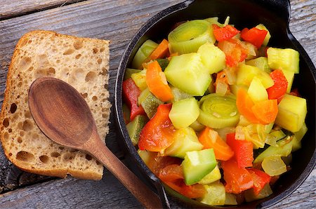 simsearch:400-07478286,k - Vegetable Stew in Black Saucepan with Brown Bread and Wooden Spoon closeup on Rustic background. Top View Stock Photo - Budget Royalty-Free & Subscription, Code: 400-07412370