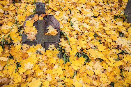 simsearch:400-07570169,k - A cross monument in a cemetery with fall leaves in the background Photographie de stock - Aubaine LD & Abonnement, Code: 400-07412492