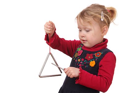 play a triangle - Little girl playing a triangle instrument on white background Stock Photo - Budget Royalty-Free & Subscription, Code: 400-07412642