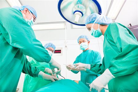 female paramedics in gloves - Team surgeon  working in operating room. Stock Photo - Budget Royalty-Free & Subscription, Code: 400-07412763
