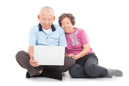 senior couple computer not smiling - happy senior couple watching or leaning with laptop Stock Photo - Budget Royalty-Free & Subscription, Code: 400-07412781