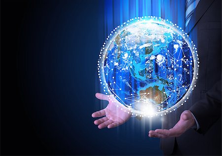 Man in suit holding a earth in hand. Communication around the earth. The concept of communication Stock Photo - Budget Royalty-Free & Subscription, Code: 400-07413766