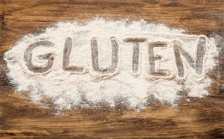 gluten word written  in wheat flour on wooden board Foto de stock - Super Valor sin royalties y Suscripción, Código: 400-07413763